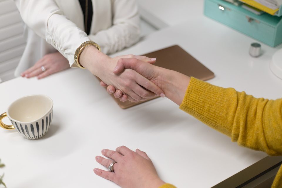 Two investors shaking hands over a wholesale contract